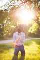 man praying on knees in sunshine