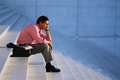 man sitting on steps contemplating life