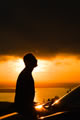 silhouette of a man looking up at twilight