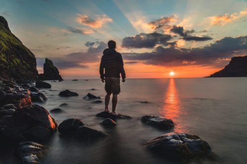 young man facing sunset